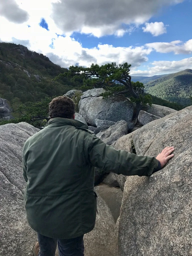 Hiker climbing through the granite boulder scramble on Old Rag