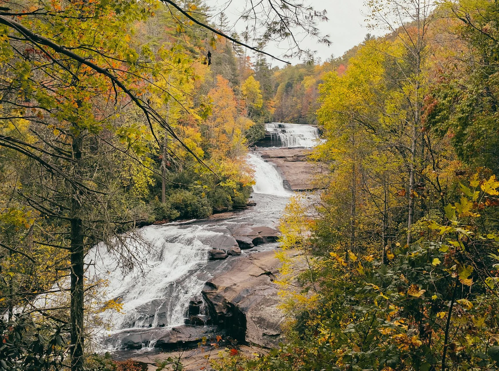 Waterfall cascading through autumn forest in North Carolina