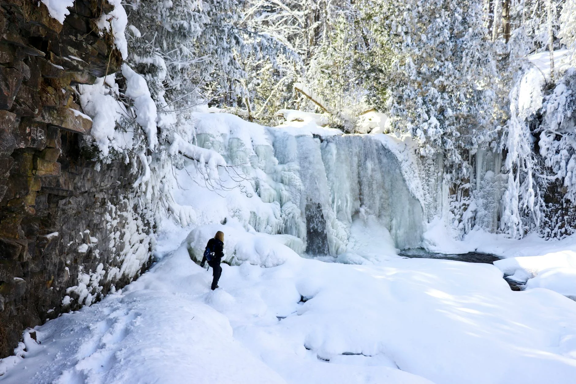 Frozen waterfall on a snowy winter trail