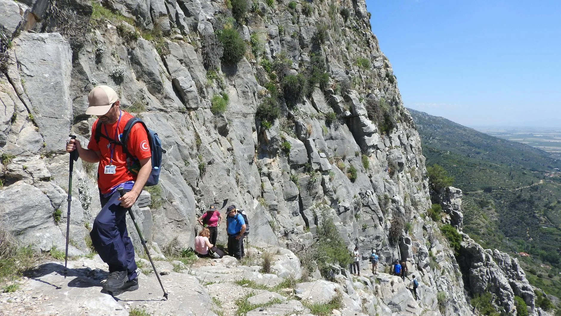 Adventurous climber on rocky cliff face