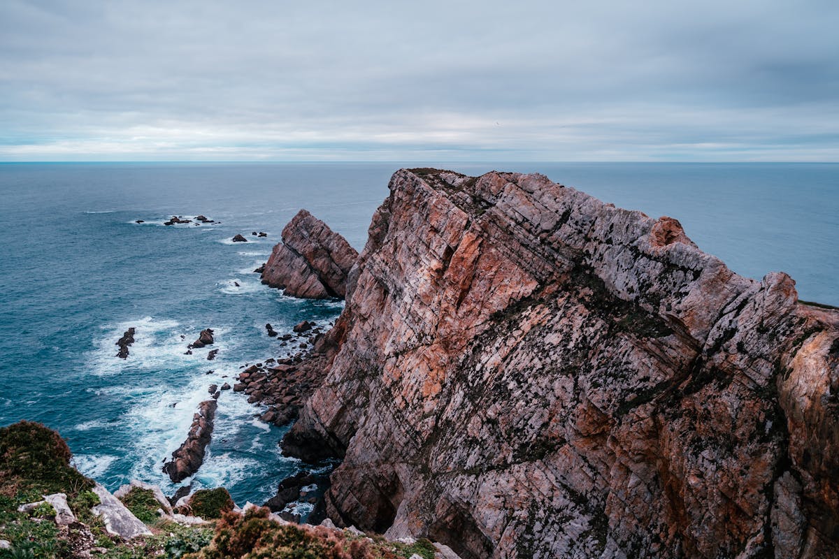 Rocky ocean coastline with waves crashing against cliffs