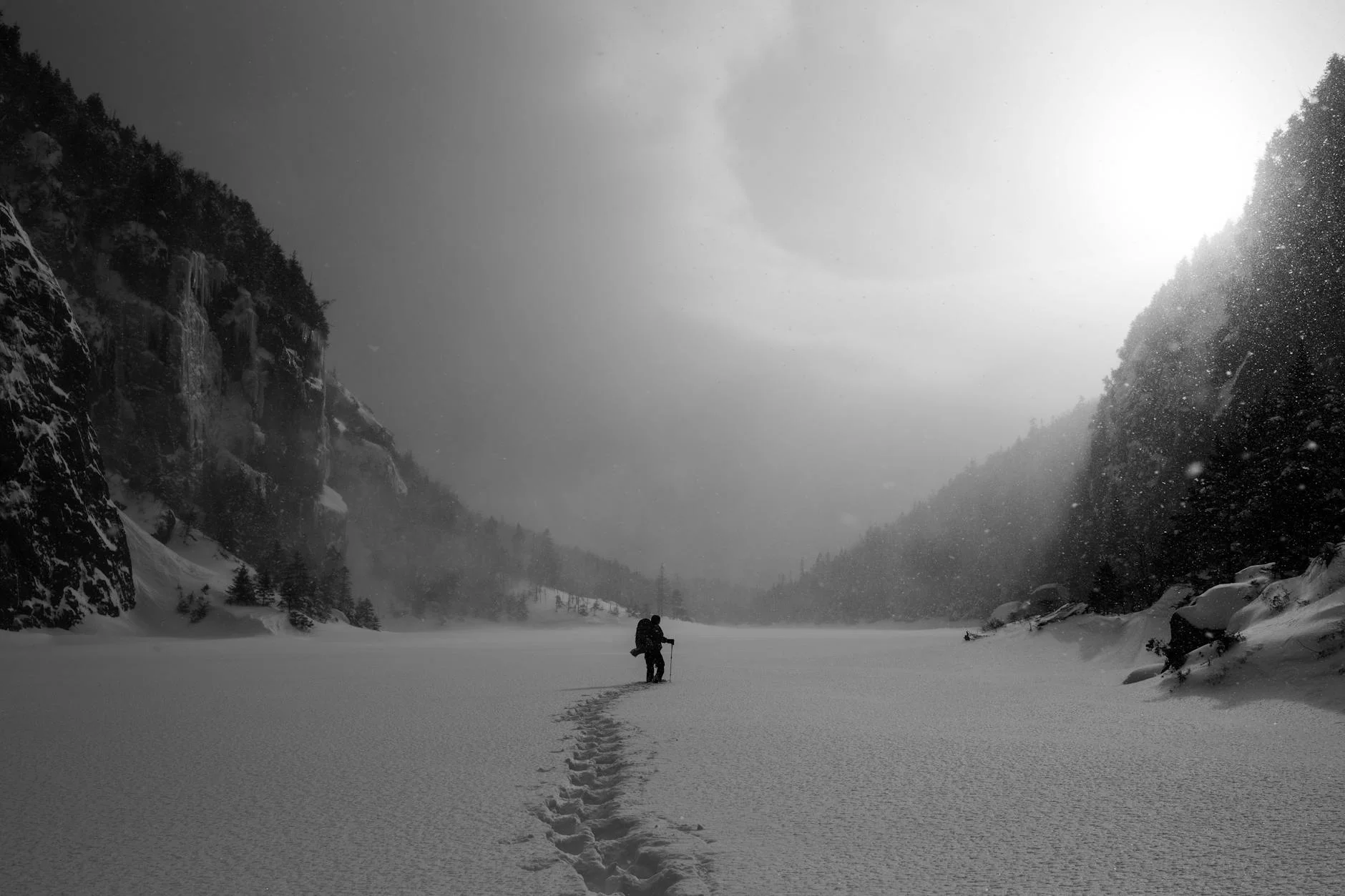 Hiker in winter backcountry surrounded by snowy scenery