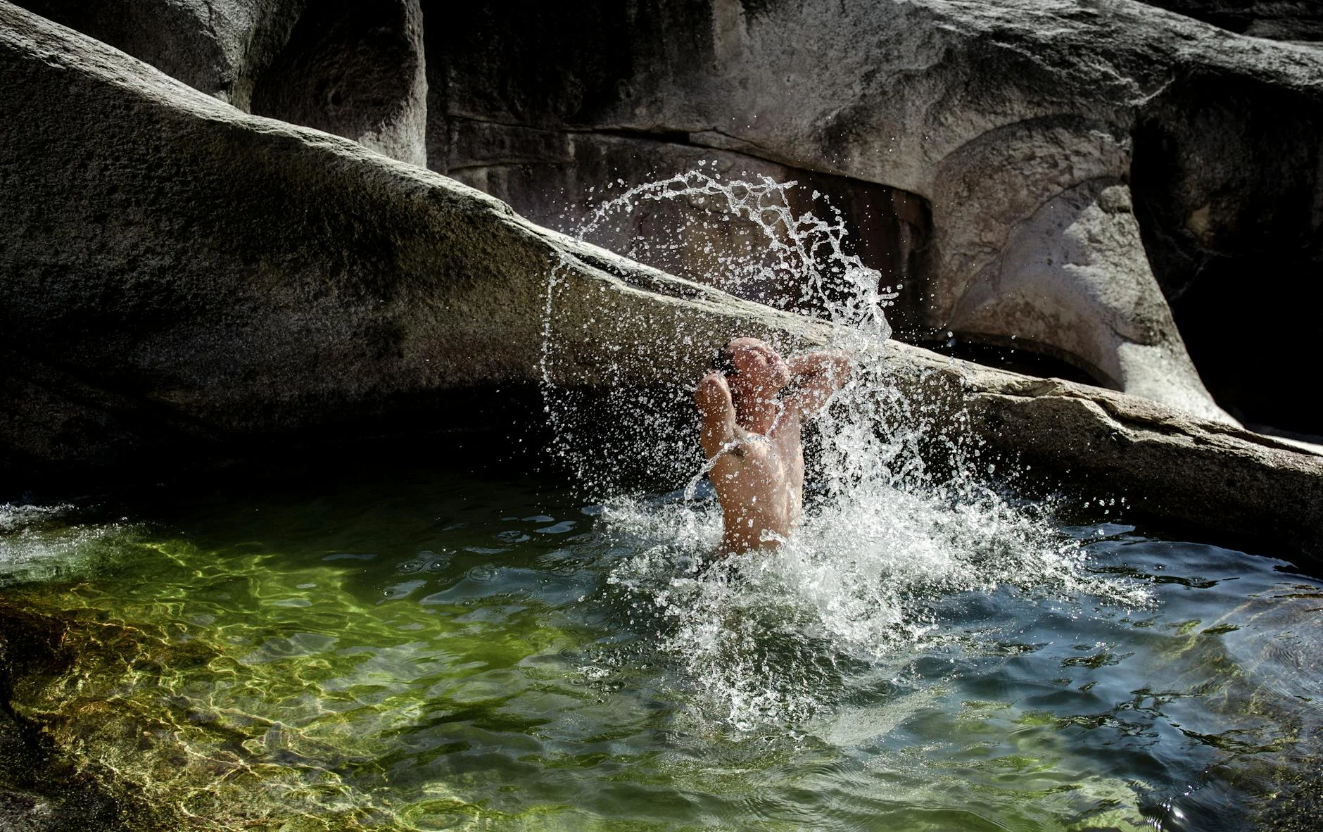 Waterfall pool in a forested gorge
