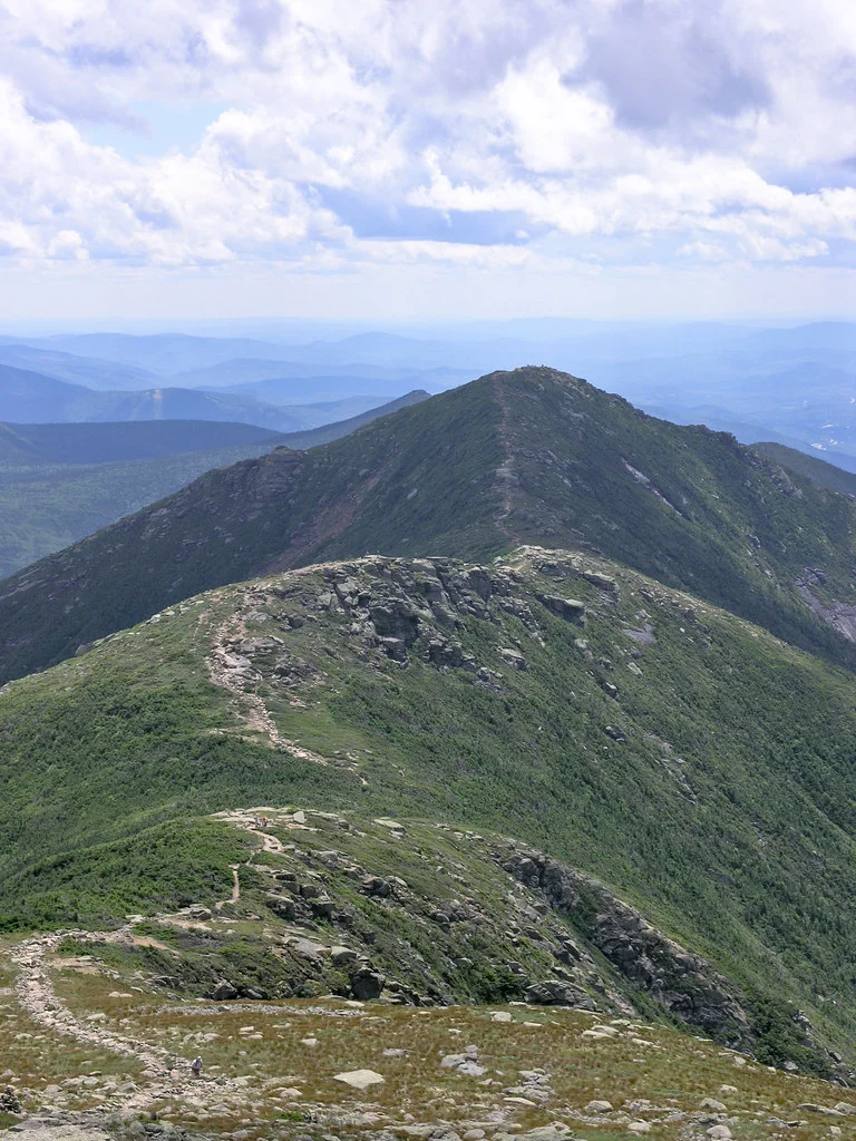 Hikers walking the open alpine ridge on Franconia Ridge