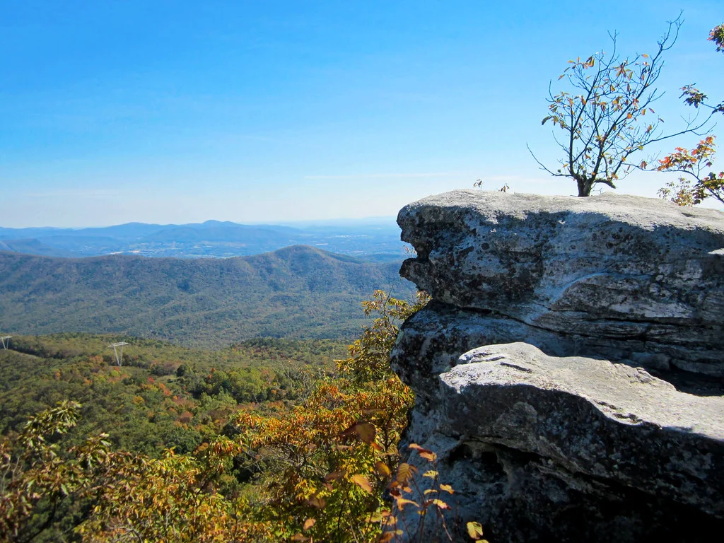 Hiker standing on the McAfee Knob ledge above the Catawba Valley